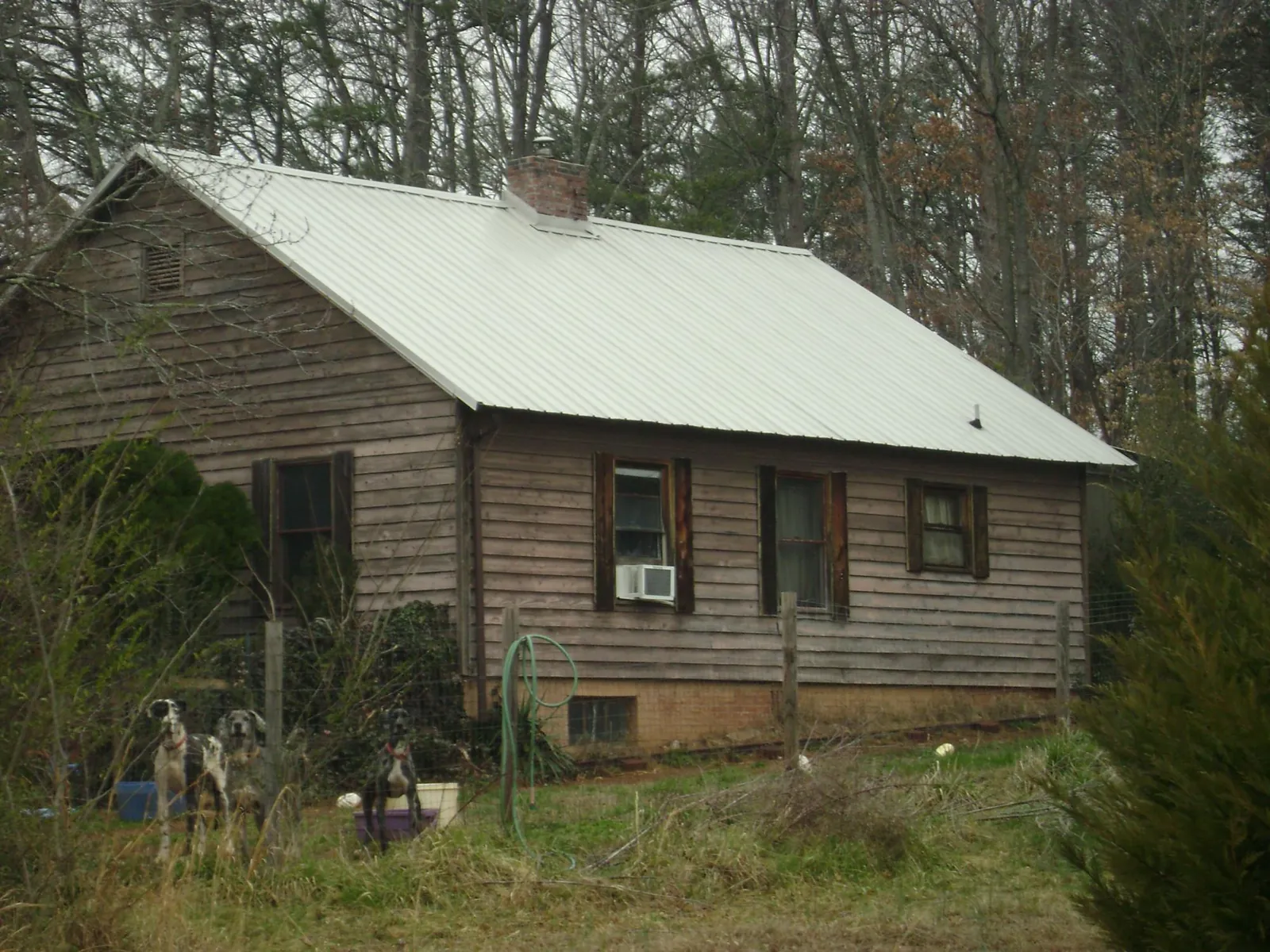 White metal roof on an old wood sided farmhouse, from a Metal Roof Installation job in West Jefferson